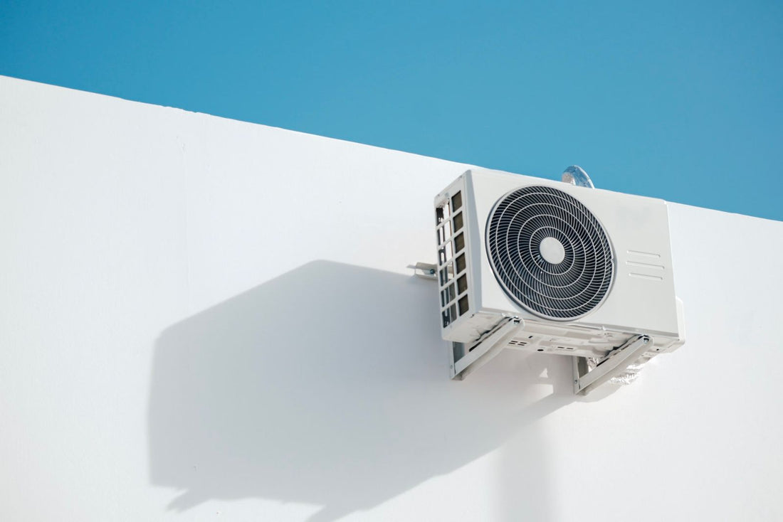 Ductless mini split outdoor condenser on a white wall, the type used by quick connect mini split systems from Zone Air and MRCOOL DIY