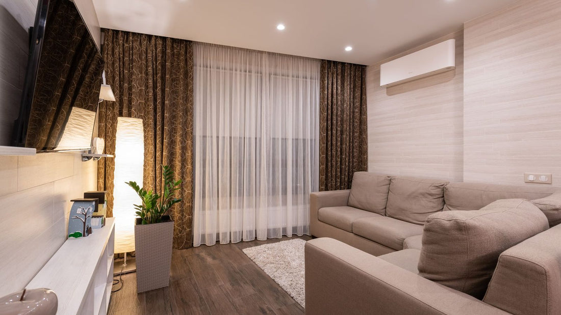 Modern wall-mounted ductless mini split indoor unit on a living room wall, one of the best variable speed heat pumps for home climate control