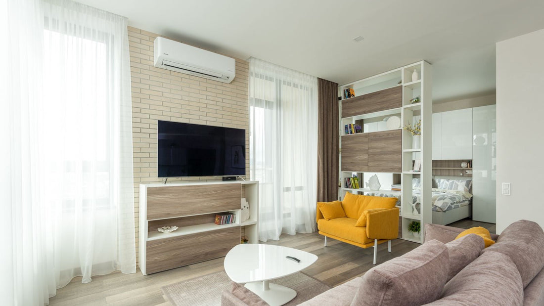 White ductless mini split wall unit on a brick living room wall, the type of pre-charged DIY install compared here: MRCOOL Easy Pro vs Zone Air