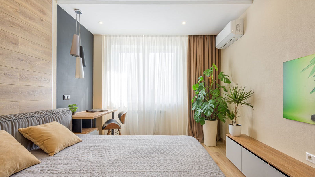White pre-charged DIY mini split wall unit mounted high on a bedroom wall, the room size a 12,000 BTU Zone Air system is built for