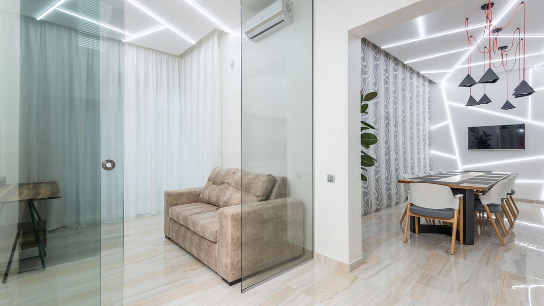 Modern apartment interior with a wall-mounted AC unit visible through glass, showing an evaporator coil what is it